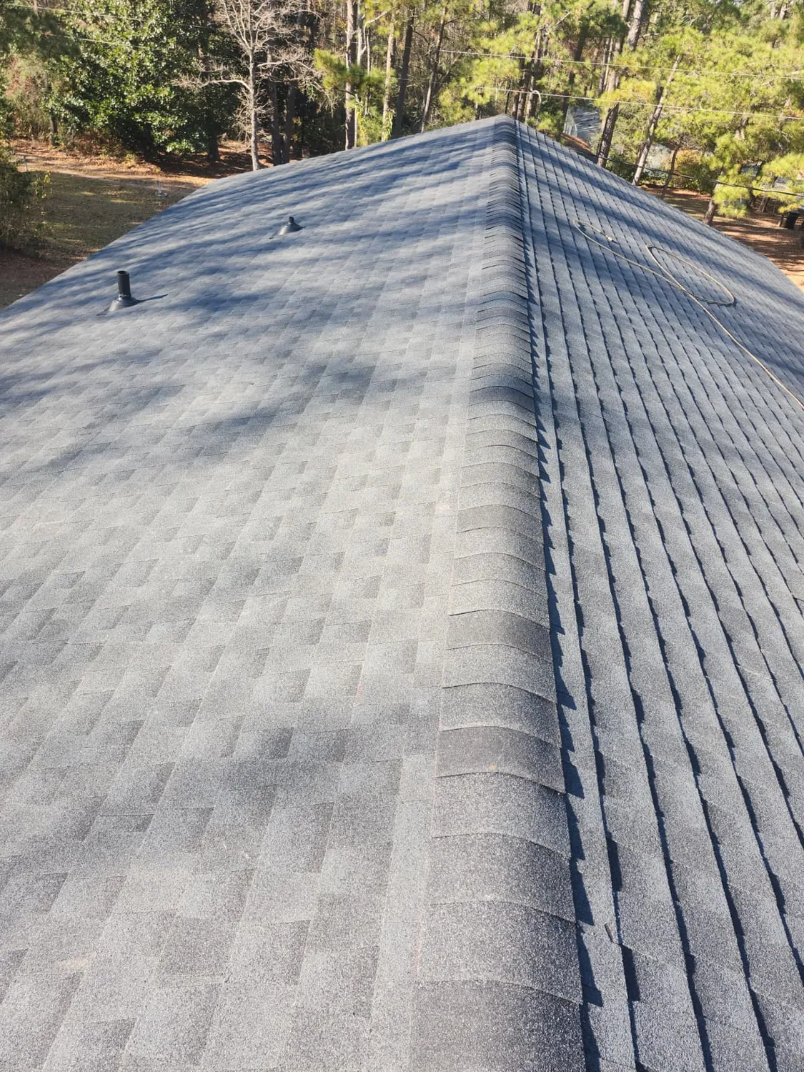 Shingle roof plane running clean from ridge to eave